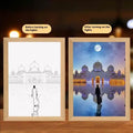 Handmade rectangular LED light painting photo frame showing a spiritual cross design, with USB cable.