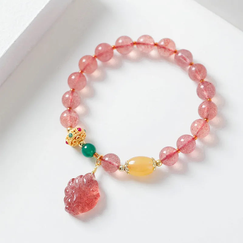 Women's Nine Tail Fox design bracelet with polished strawberry quartz crystal beads.