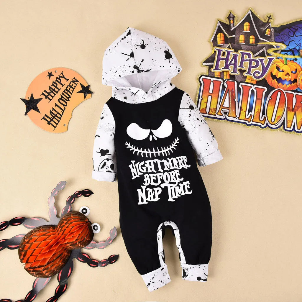 Halloween romper in black cotton with long sleeves and attached hood, shown on a neutral mannequin