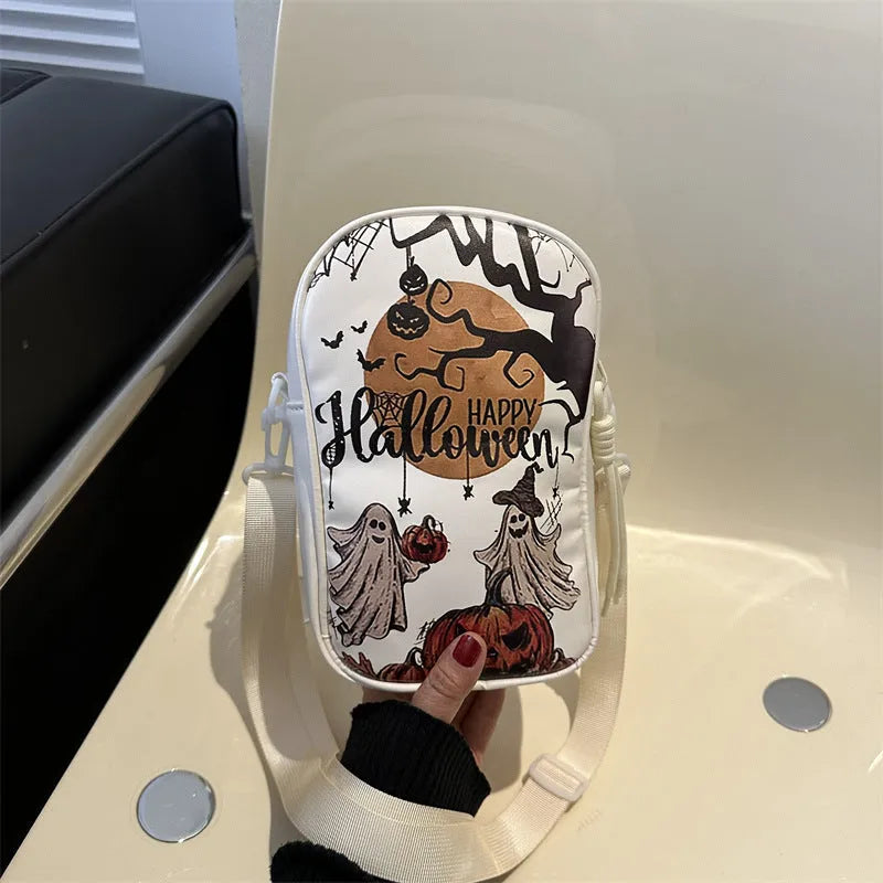 Halloween graffiti print crossbody phone bag with cartoon pumpkins, in multiple colours.