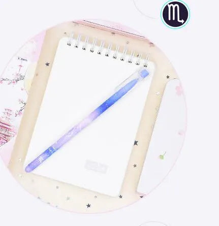 Box of 12 plastic gel pens with quick-drying ink and constellation-themed designs in assorted colours