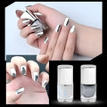 Bottle of mirror silver nail polish with brush and stainless-steel ball for mixing