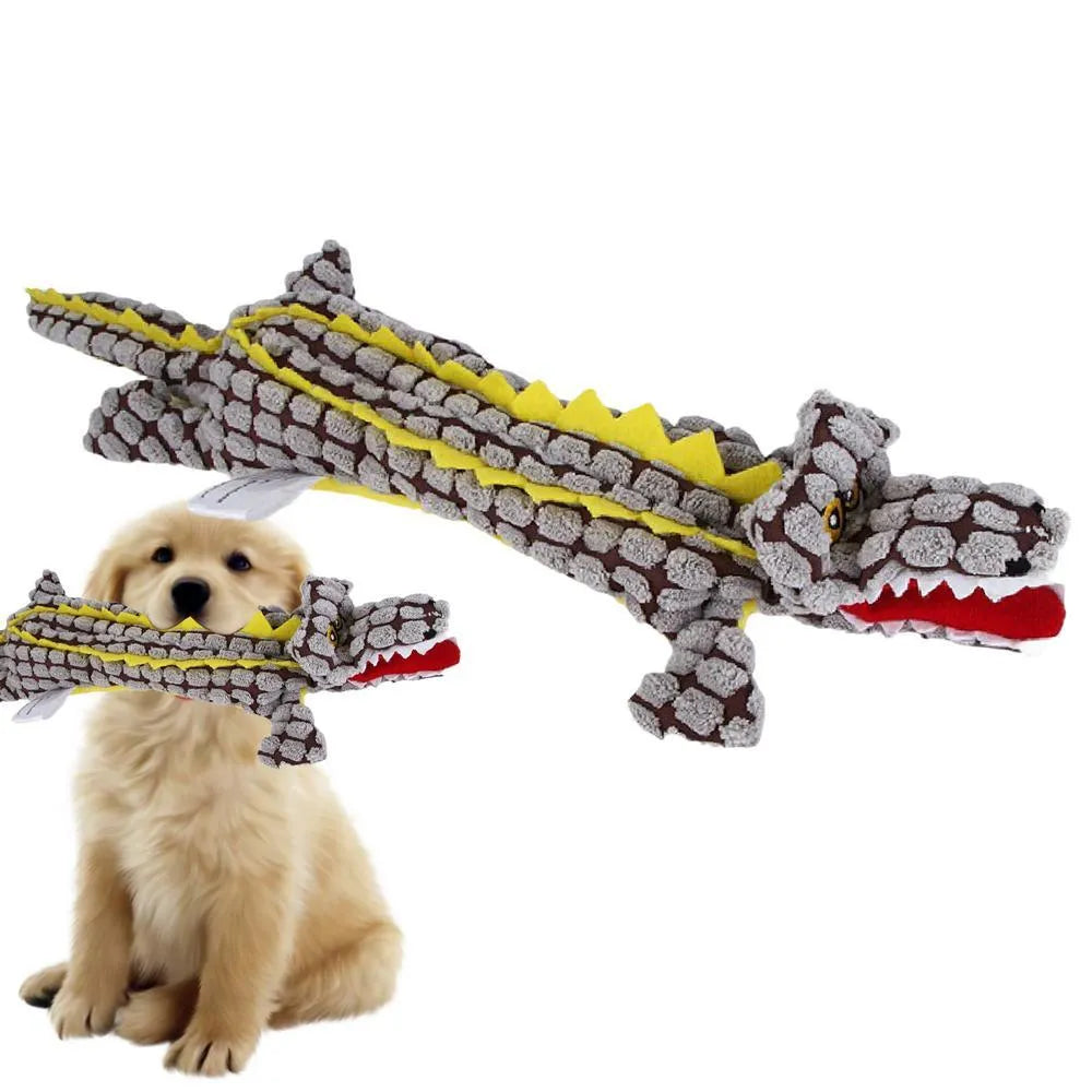 Blue crocodile-shaped plush squeaky dog toy with corduroy fabric on a wooden floor.