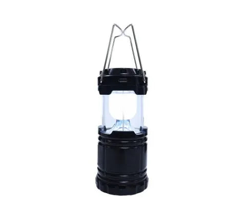 COB LED camping lantern in black, telescopic with hook, on outdoor background