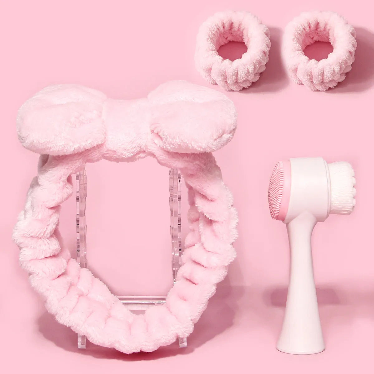 Facial brush and coral fleece hair band set in purple, grey, white, and pink colours.