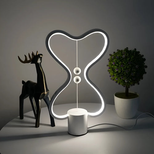 7-colour balance LED night light with magnetic suspension, USB powered, on a desk showing warm white glow