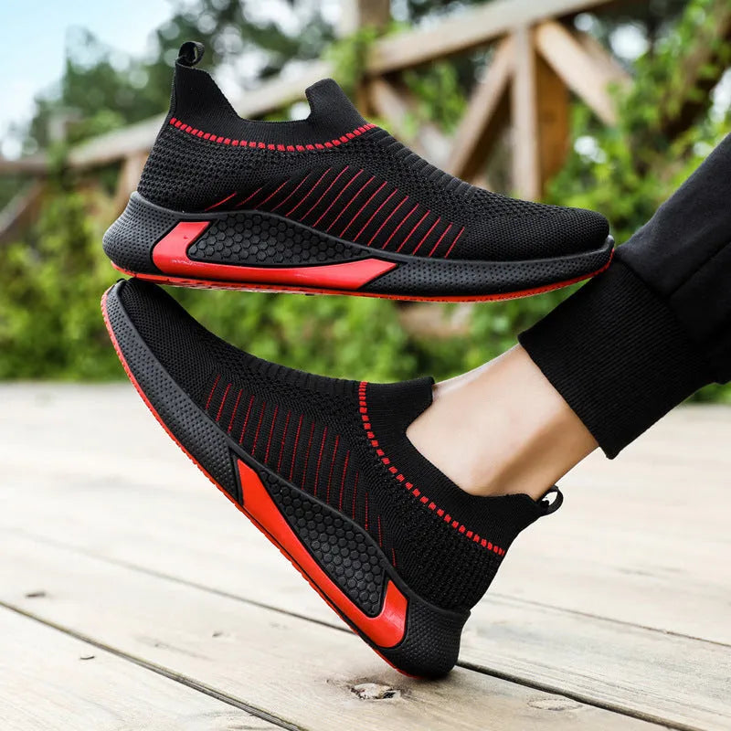 Men's black and white striped slip-on sneakers with lace-up front and mesh design.