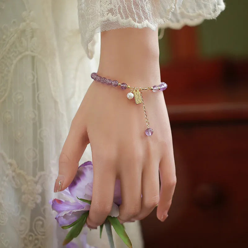 Natural crystal women's bracelet with lavender amethyst stones and animal/Zodiac motif in dark and light colour variations