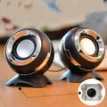 Compact black and gold desktop computer speakers with USB cable