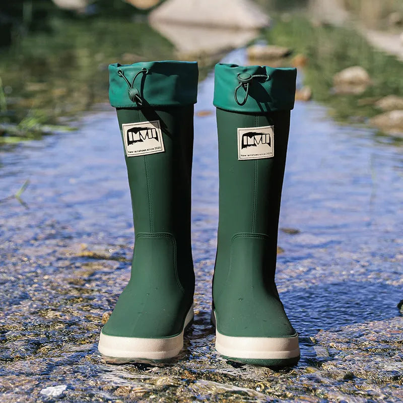 Pair of solid colour high tube PVC rain boots with a low heel on a non-slip sole.