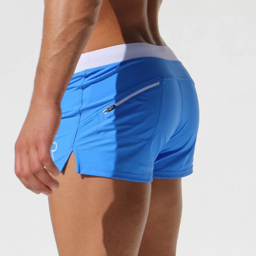 Cotton men sports shorts boxers in white, blue, navy, purple, green, and black for swimwear and beach use.