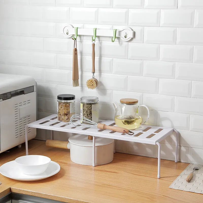 White telescopic kitchen rack with adjustable height showing extended and compressed positions