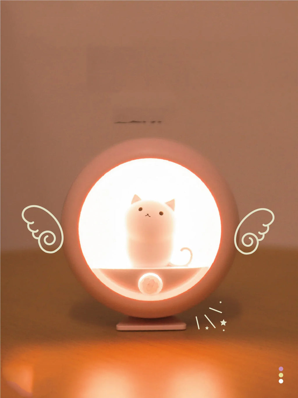 White sleep lamp with star projection and multicolour lighting options on bedside table