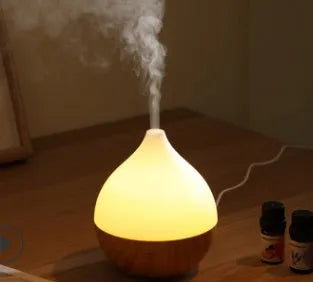 Asakusa wood grain finish vase-shaped aroma diffuser with USB cable on a wooden surface.