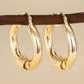 Women's geometric copper earrings with ring and line design in golden colours, ear clip style