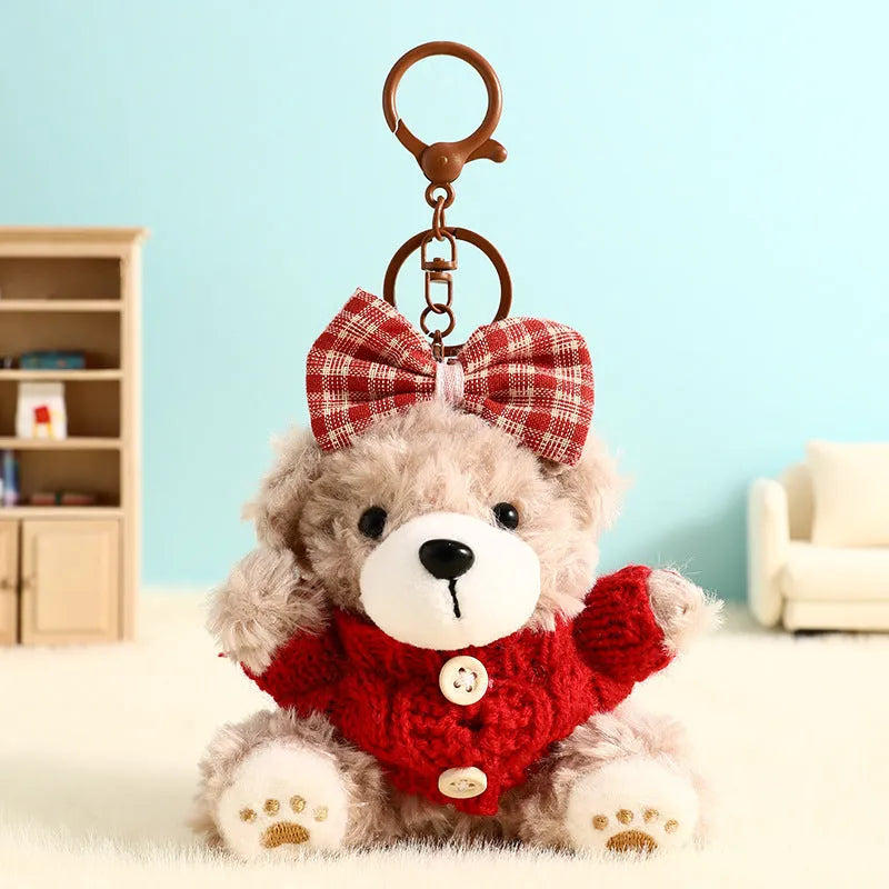 Plush biscuit bear keychain pendant with a red bow on a metal keyring