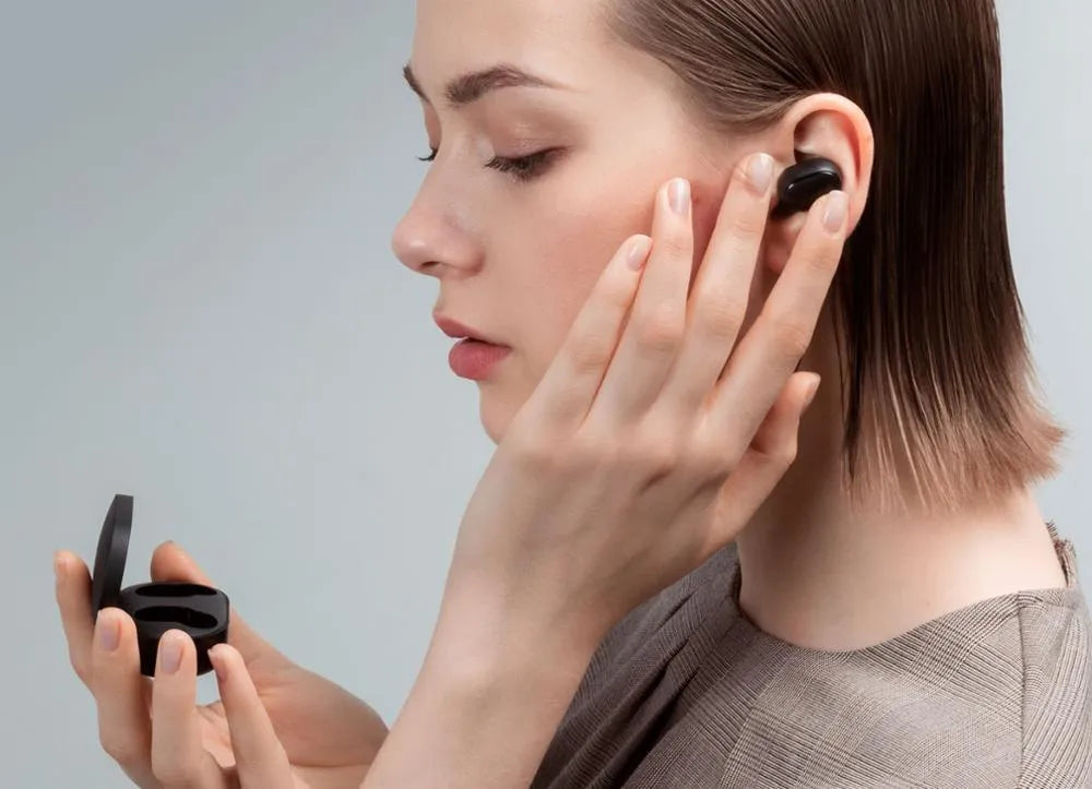Redmi AirDots 2 black true wireless earbuds next to their compact charging case on a white background.