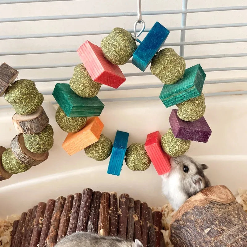 Hamster chew toy featuring applewood sticks and decorative straw balls with colourful sequins