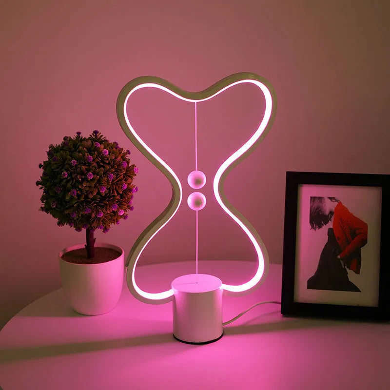7-colour balance LED night light with magnetic suspension, USB powered, on a desk showing warm white glow
