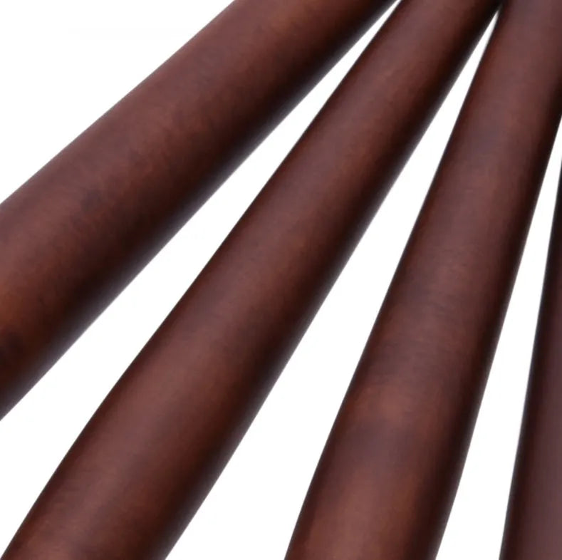 10 brown makeup brushes with wooden handles and nylon bristles laid out on a flat surface
