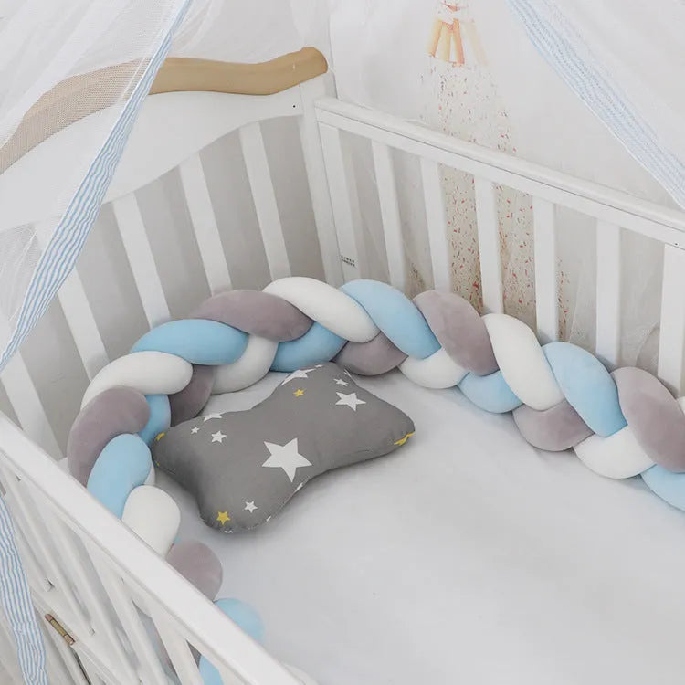Baby cot bumper braid in spandex crystal velvet, shown in a light grey colour, wrapped around white crib rails.
