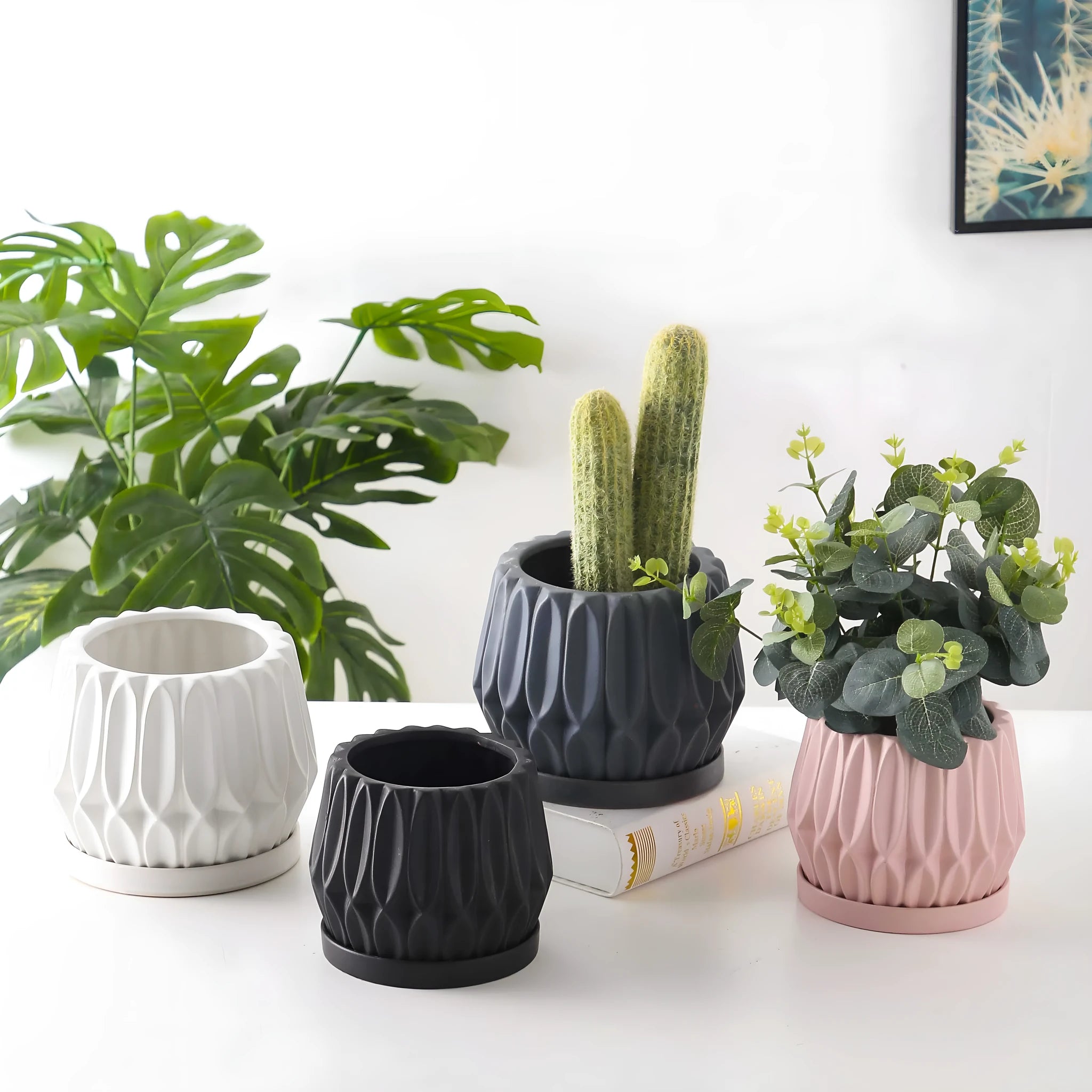A simple grey ceramic flowerpot on a tabletop, medium sized for plants.