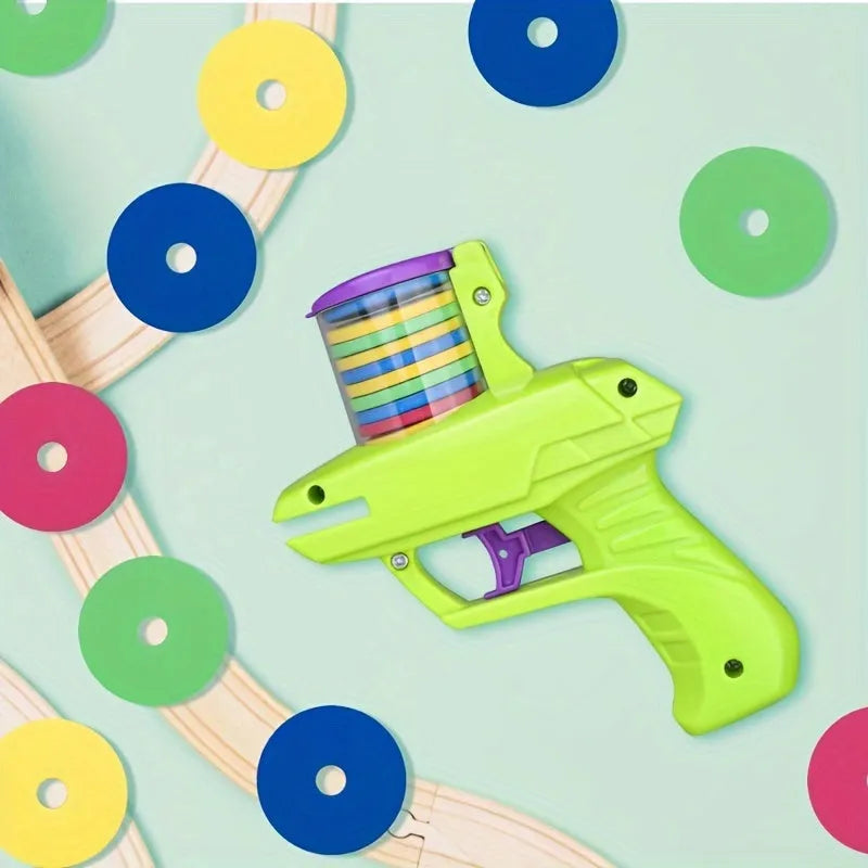 Green and purple manual cat toy launcher with foam discs for indoor pet play