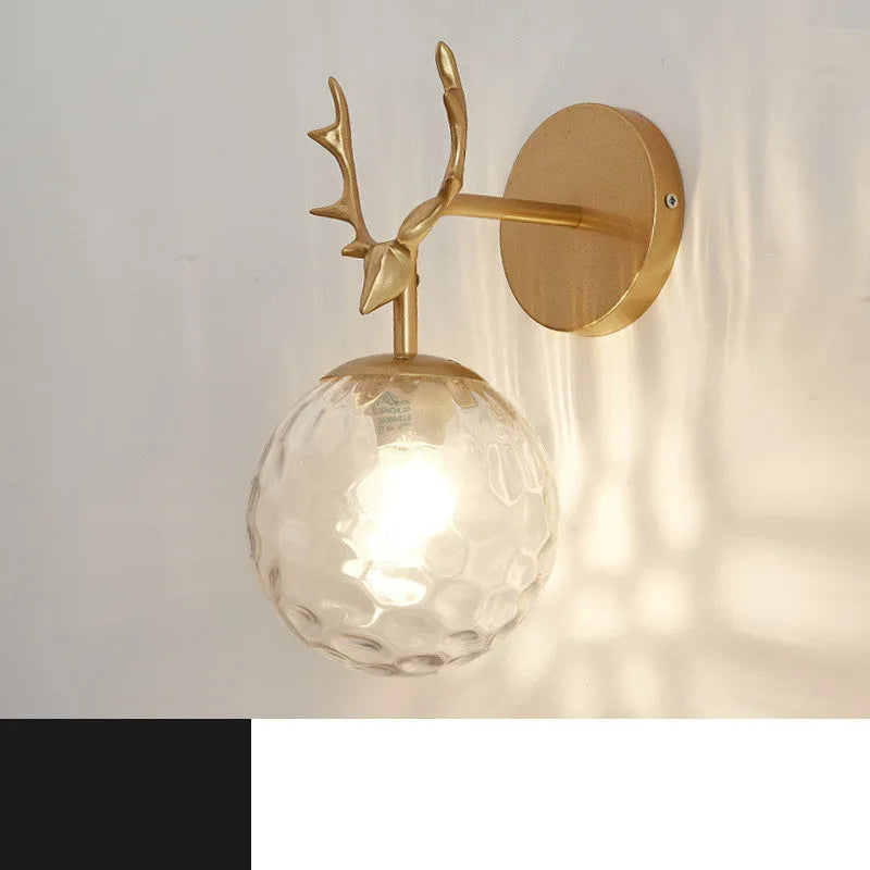 Round glass Nordic wall lamp with golden water pattern finish on a white wall.