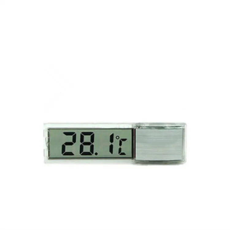 Gold digital thermometer mounted on aquarium glass showing temperature reading