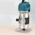 800W electric wood polishing trimmer with silver aluminium casing and a black handle on a workbench.
