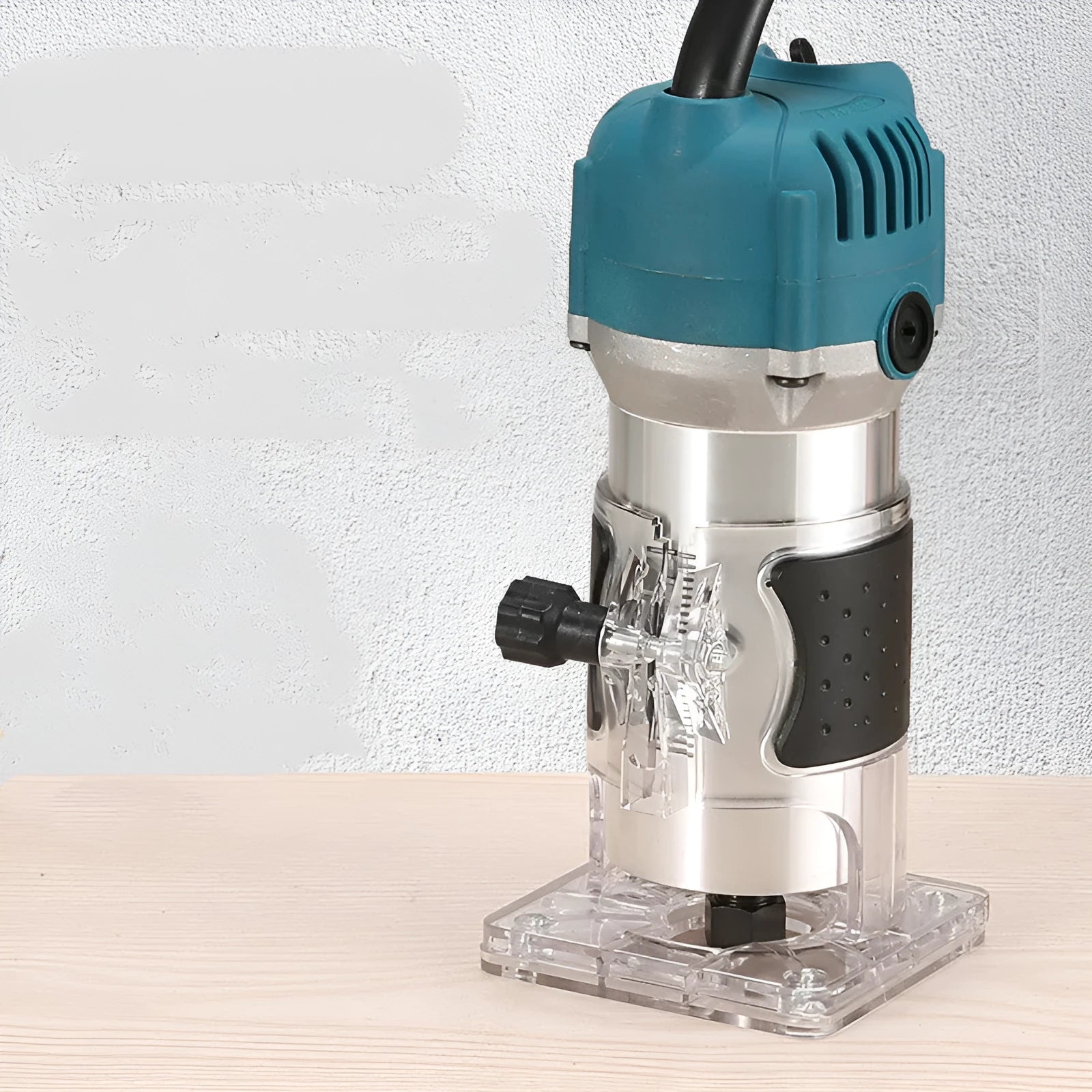 800W electric wood polishing trimmer with silver aluminium casing and a black handle on a workbench.