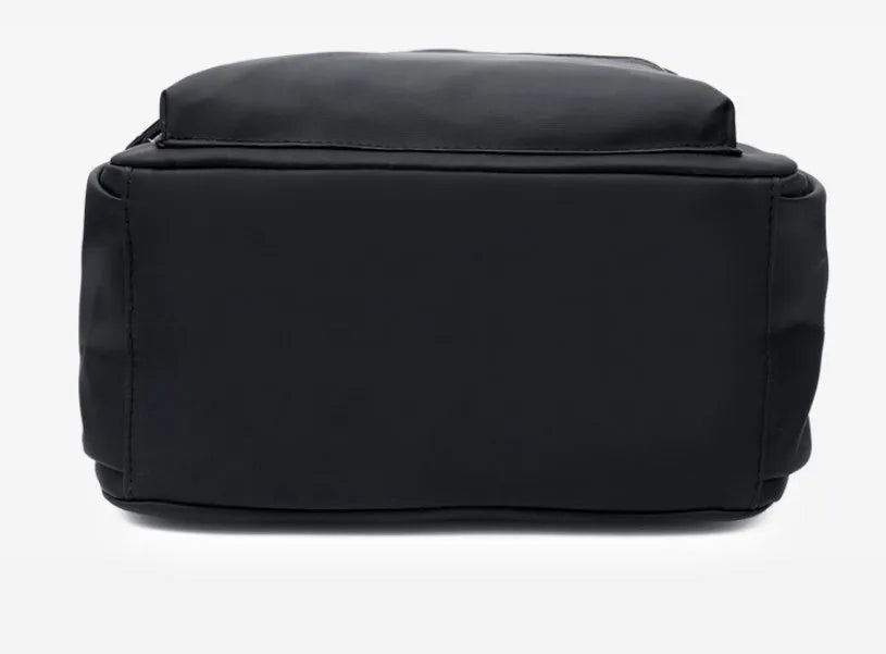 Black waterproof Oxford cloth backpack for women, 34x26x13cm, with two straps and front pocket on plain background