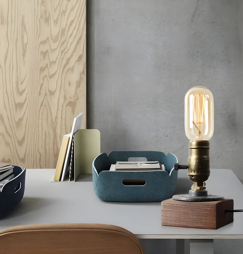 Water pipe table lamp with wood and iron construction, 9 cm wide, 13 cm high, on a wooden bedside table