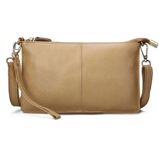 Lady's cowhide leather slant bag in apricot colour with hand strap and shoulder strap showing zipper compartments