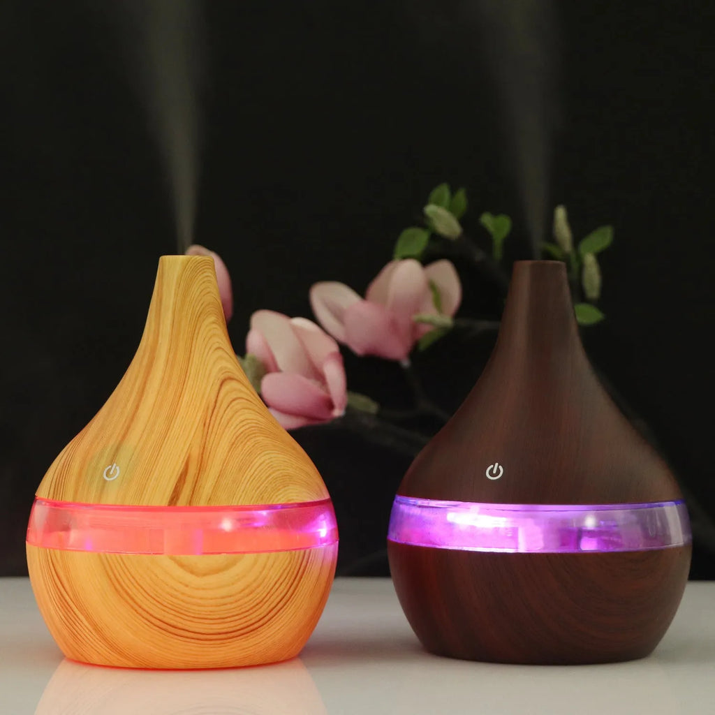 Columnar USB mini air purifier and humidifier in light wood grain finish on a desk.