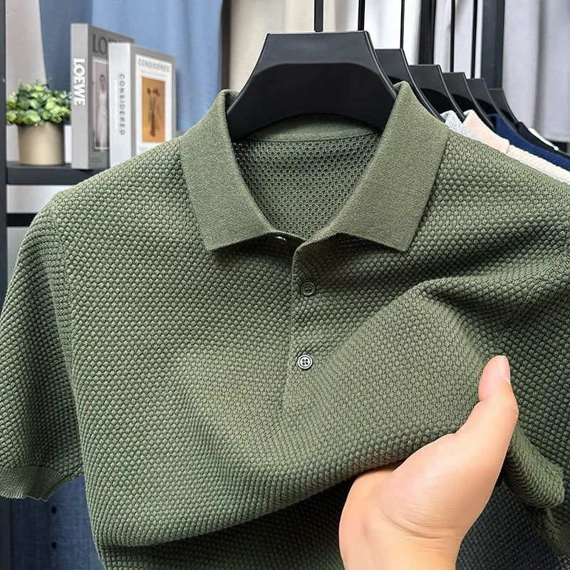 Man wearing a loose grey cotton short sleeve pullover sweater in a casual setting