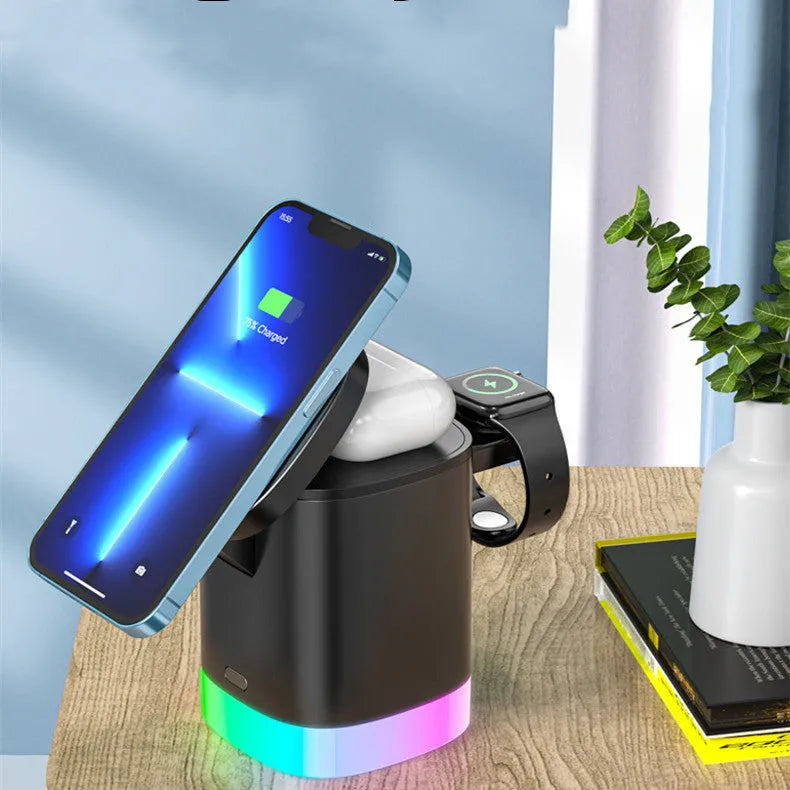 Black foldable 3-in-1 magnetic wireless charging station showing phone, watch and earbuds charging with RGB light on.