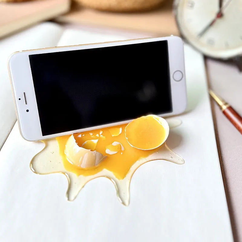 Broken egg shaped decompression toy mobile phone holder measuring 15x17cm in broken egg colour