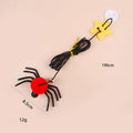 Red and yellow feather cat toy hanging from door on elastic rope with bell spider element for indoor feline play