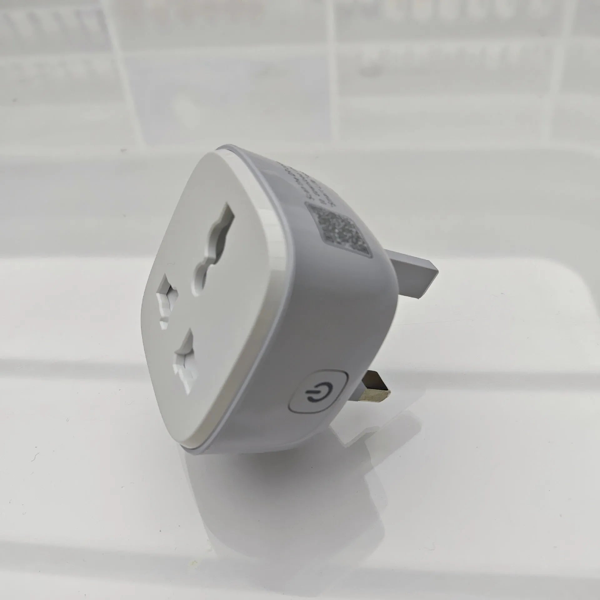 White smart WiFi socket with EU plug standard, timer and overload protection functions on white background