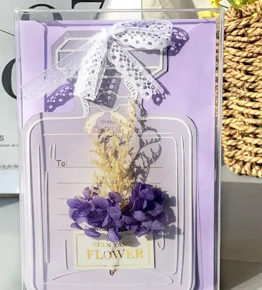 Handmade 3D butterfly-shaped greeting card with artificial flowers in a box, alongside its matching envelope.