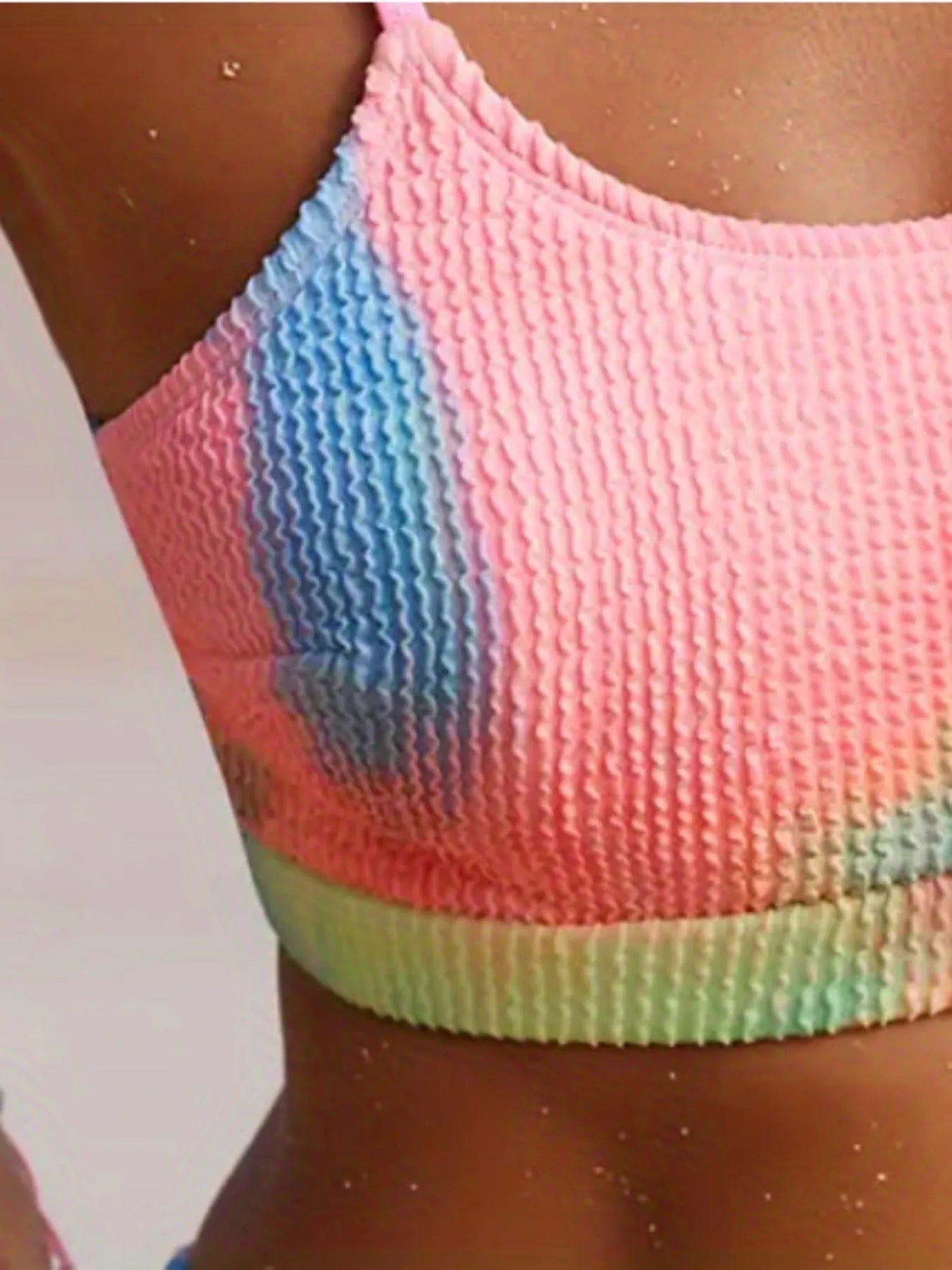Women's orange and blue tie-dye pleated split bikini set on a mannequin