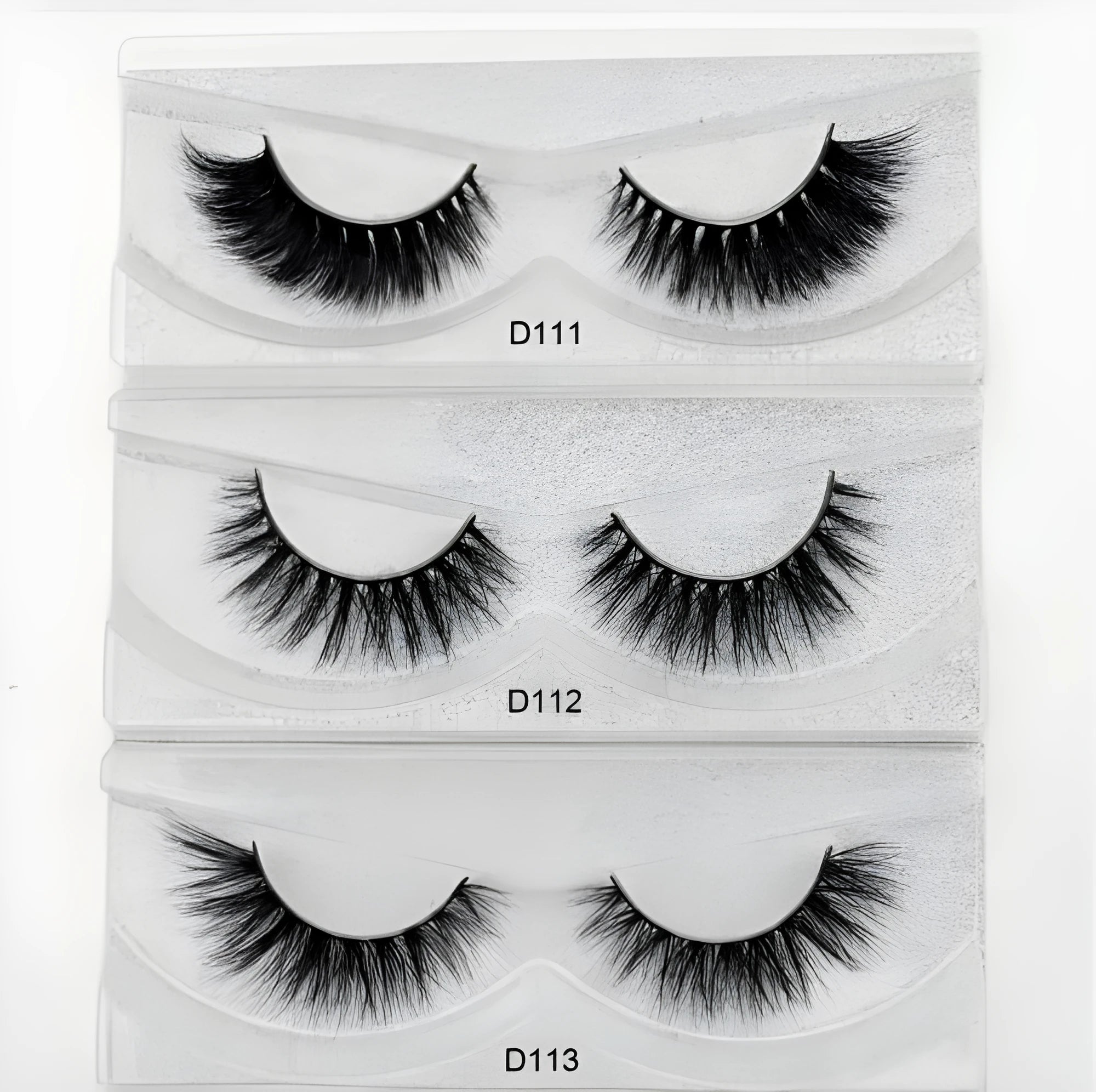 Pair of faux mink eyelashes with long tail and cotton stem against white background