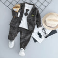 Grey cotton three-piece suit for a toddler boy on a hanger.