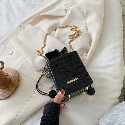 Korean-style small black PU bucket bag with a silver chain strap, shown open.