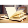 Brown and white kraft paper sketchbooks showing flat-lay wireless binding and open pages.