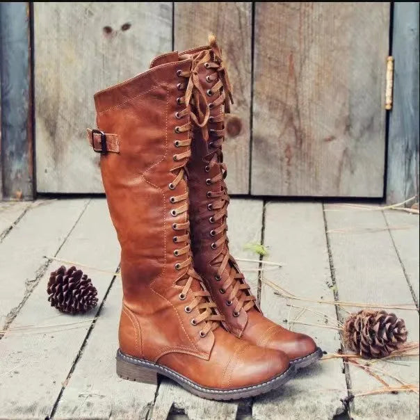 Black women's chunky heel high-leg boots with a round toe and short stout heel on a plain background.