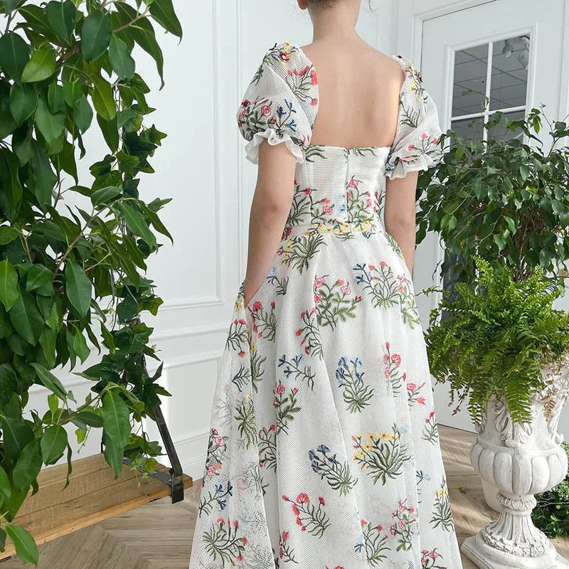 Women's fitted waist backless embroidered floral white two-piece set with mid-length skirt on white background