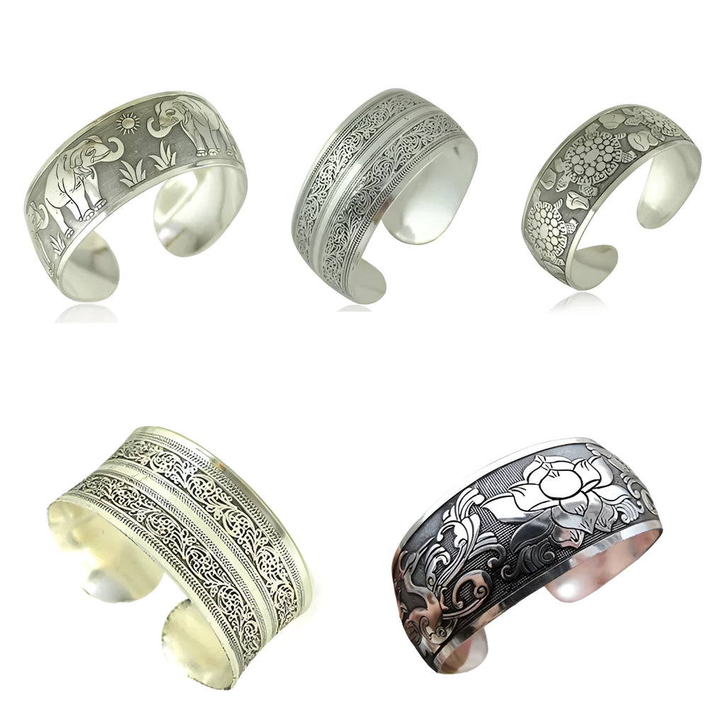 Carved open ethnic bracelet with Miao silver style design in alloy material showing elephant or turtle colour motifs