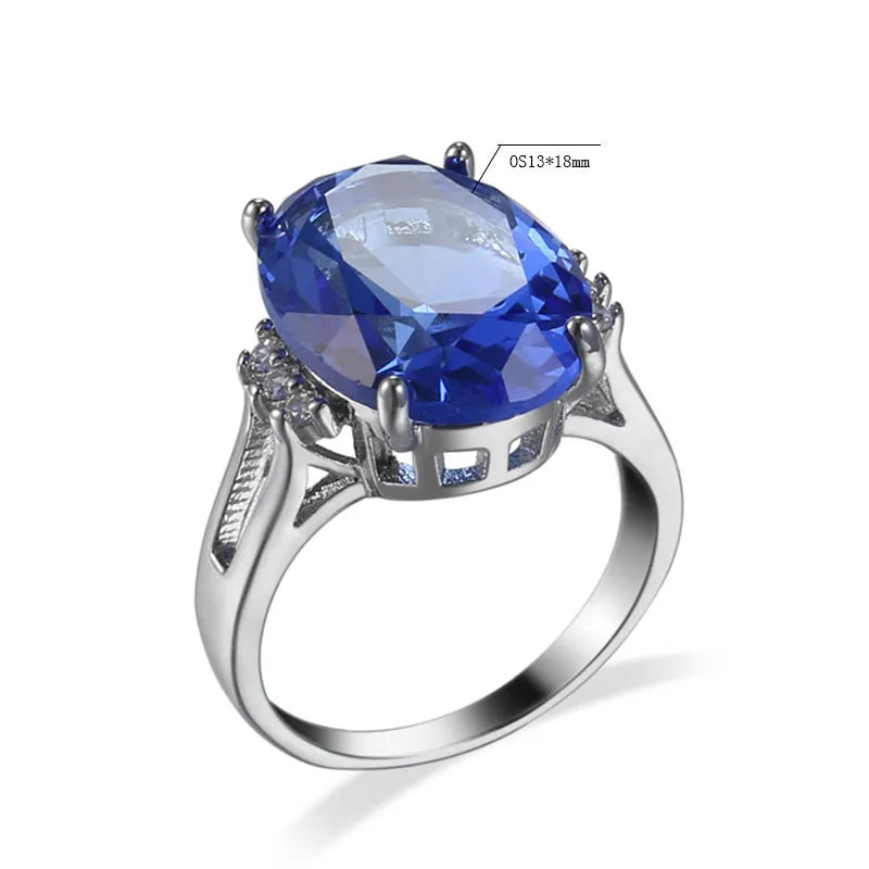 Geometric copper ring with blue black electroplated finish and an elliptical zircon centrepiece.